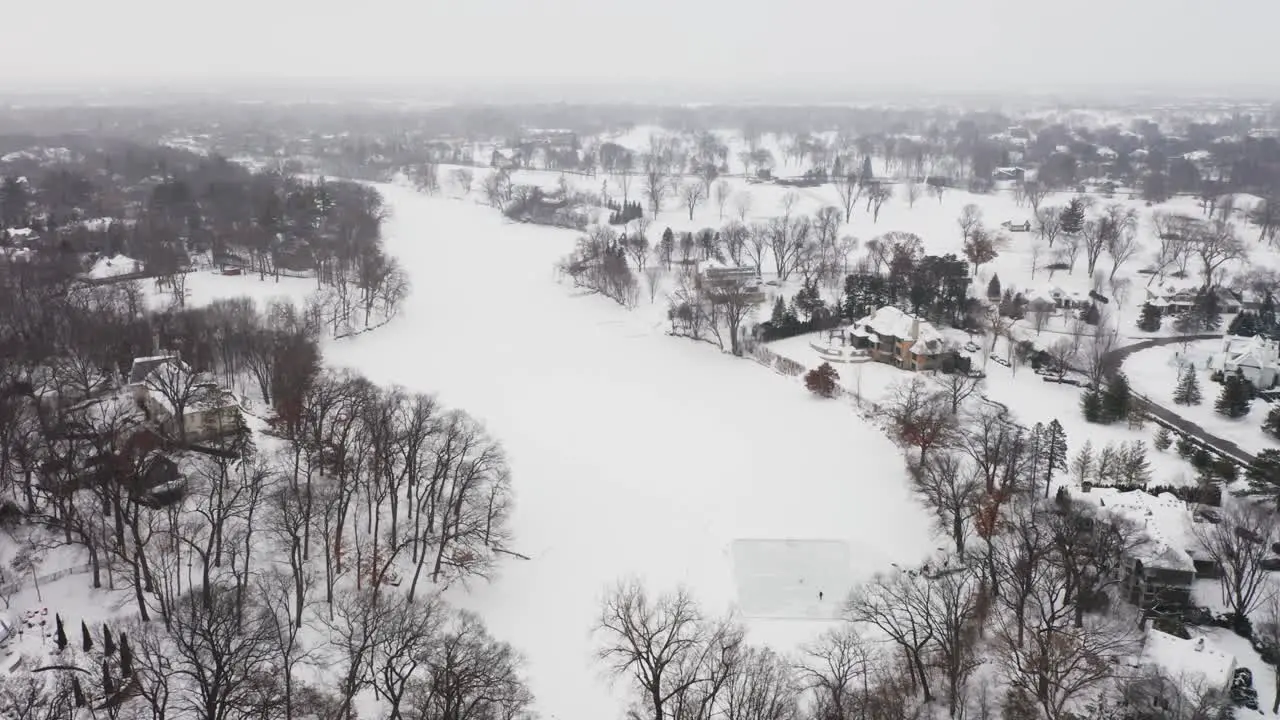 Aerial people skating on a homemade ice rink on a frozen lake