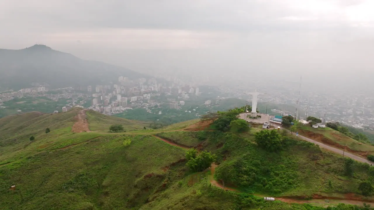 Wide aerial footage of the Cristo Rey statue in the Valle De Cauca city of Cali Colombia