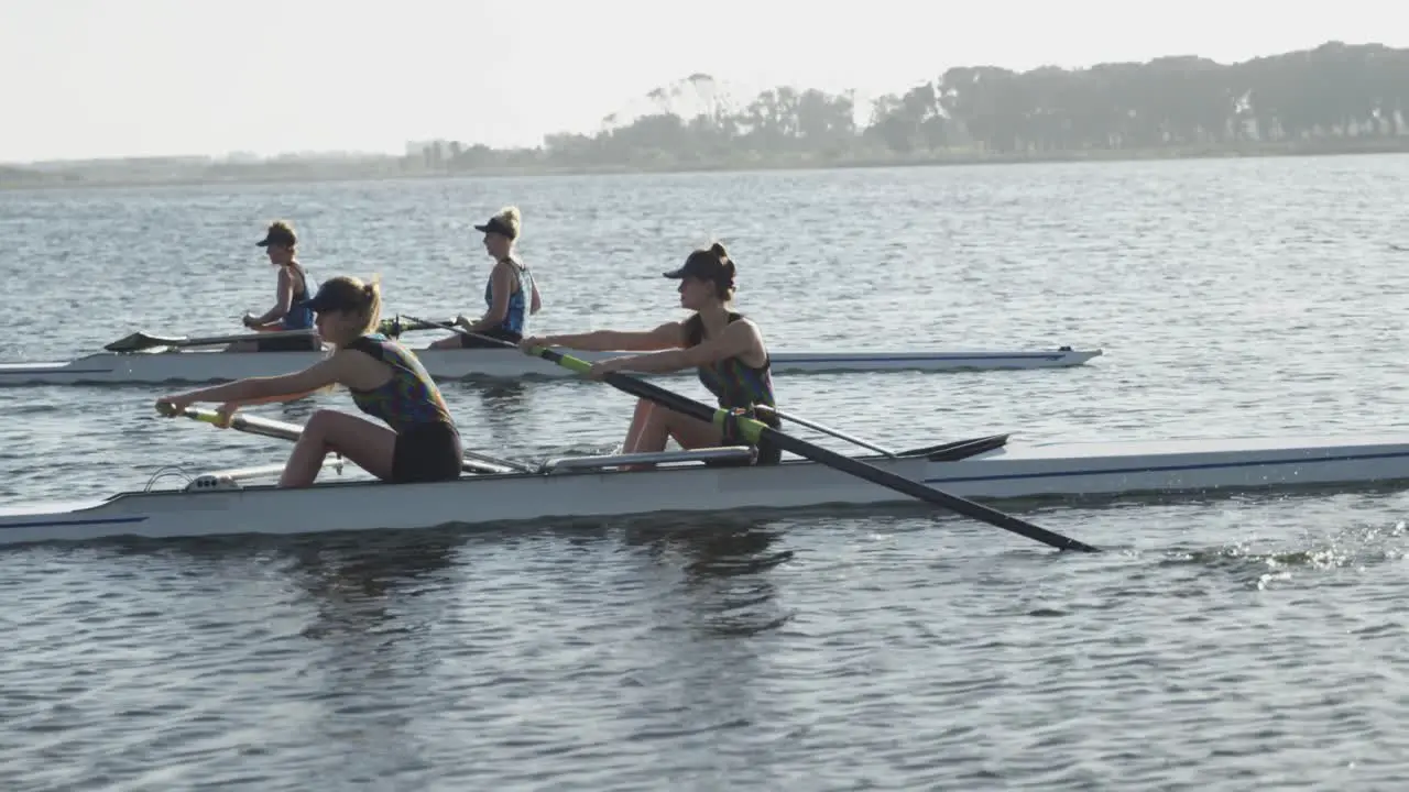 Female rowing team training on a river