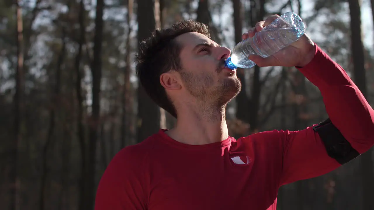 Man drinking water and resting after hard workout