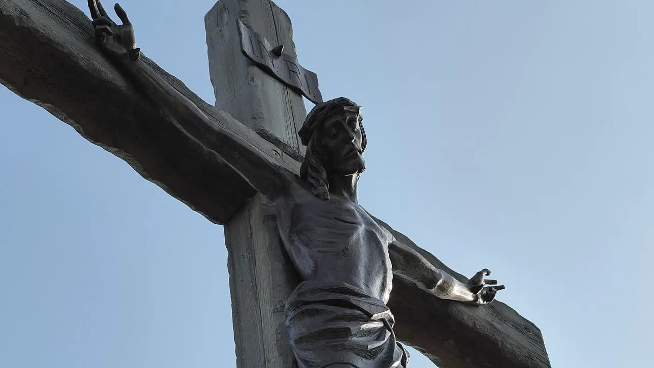 The Crucifixion of Jesus in bronze and golden sunlight