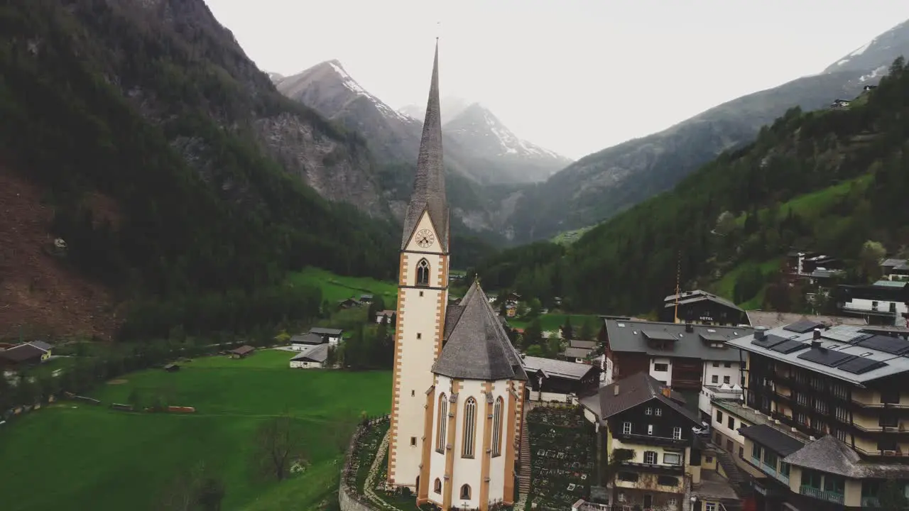 Nostalgic church in a green valley surrounded by the Austrian alps