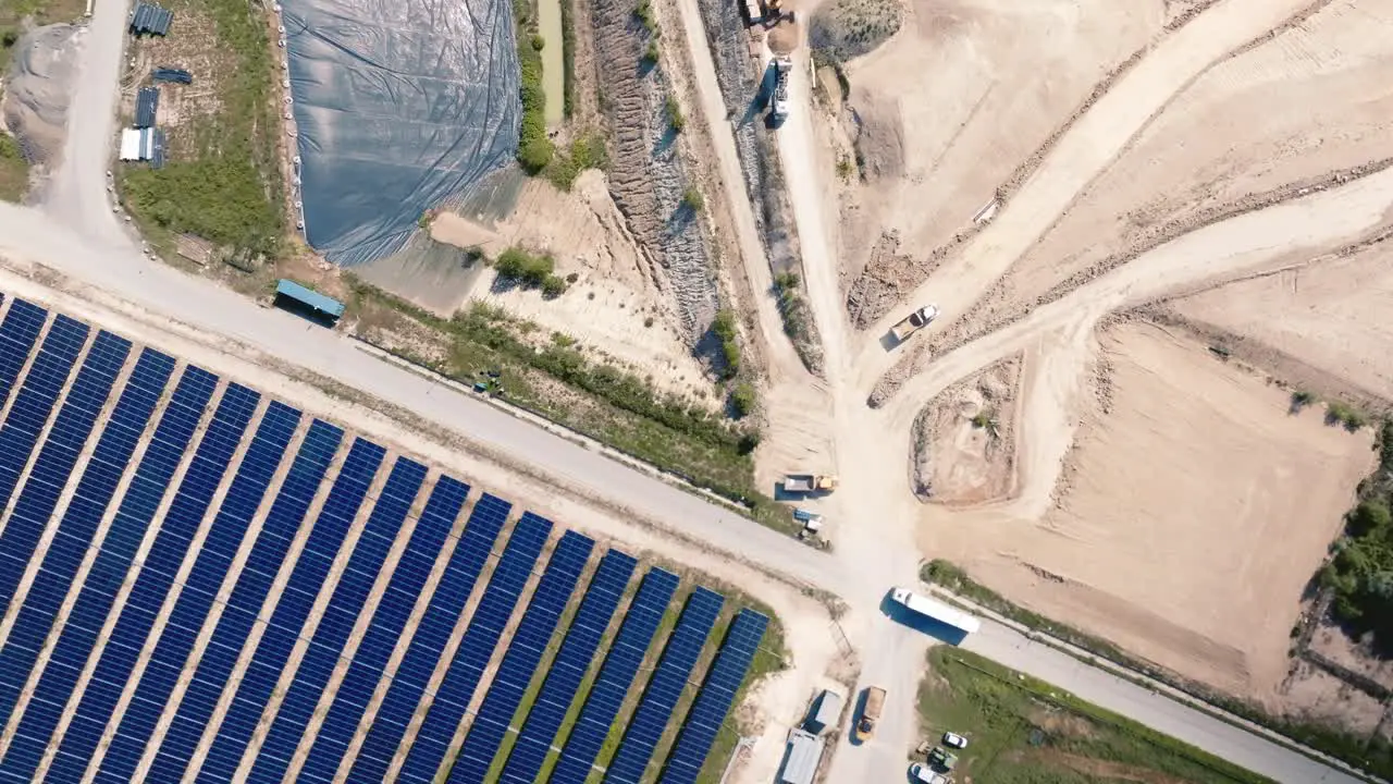 Aerial view of a solar panel installation next to a landfill site for non-recycled waste