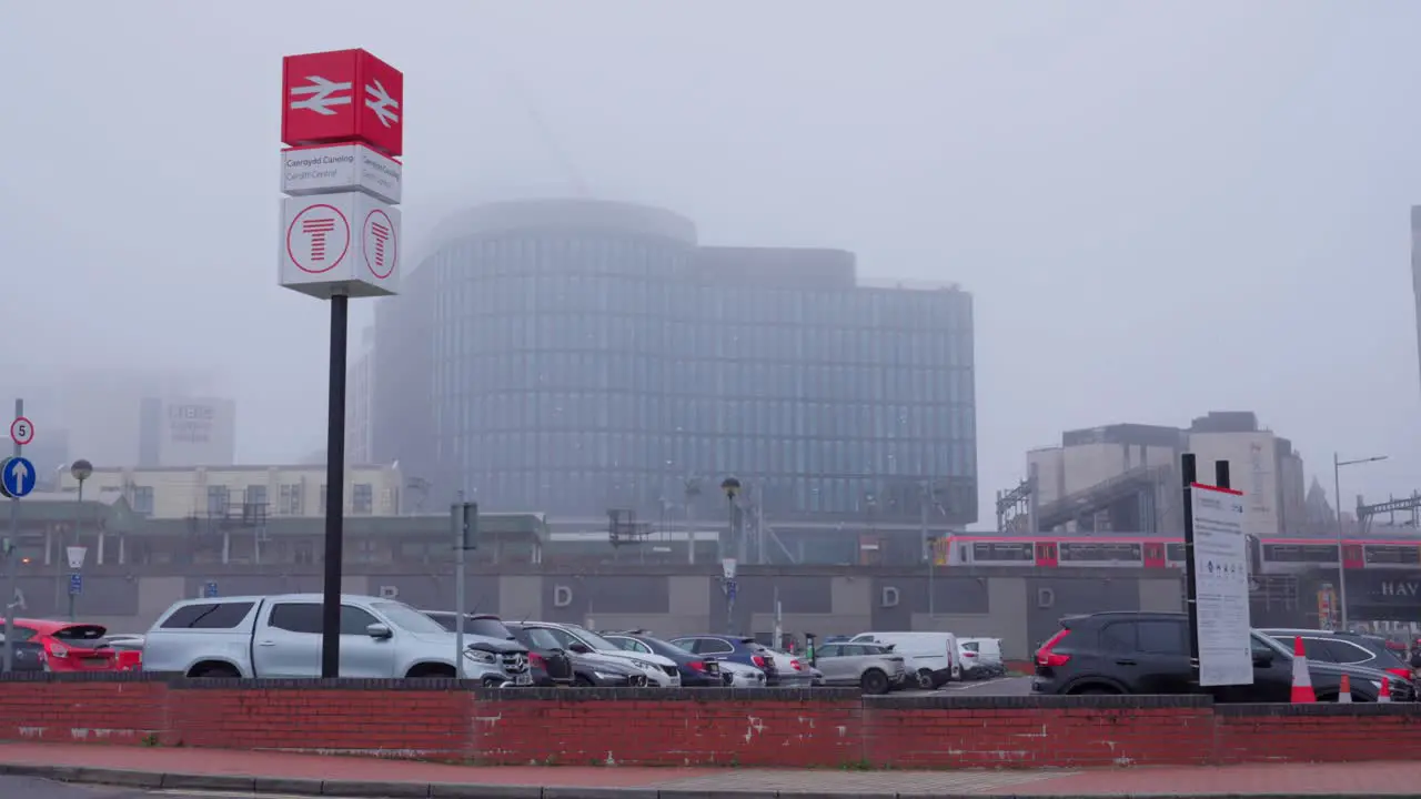 Cardiff train station on a foggy winter's day a train leaves the station