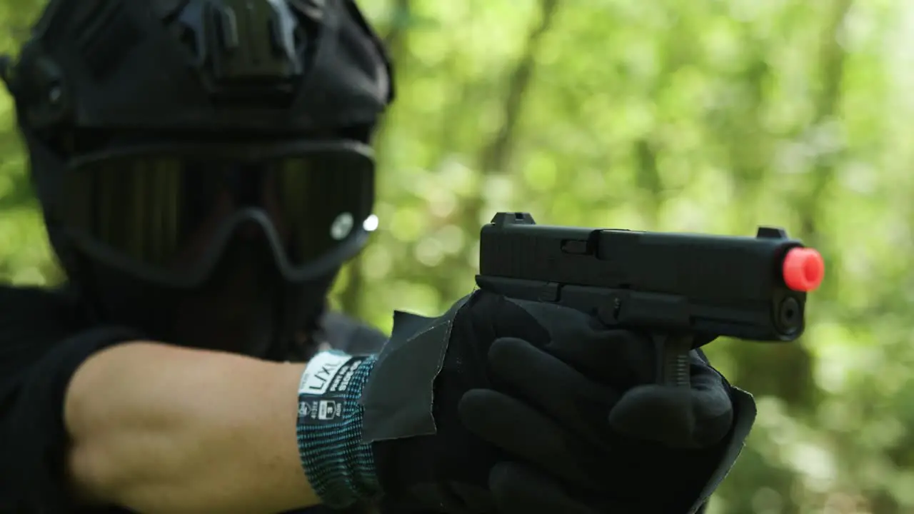 Army guy looking down his pistol sights and shoot the target