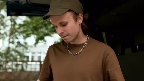 Man with drumsticks outdoors