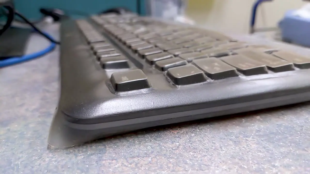 Close up slow pan over a hospital office keyboard