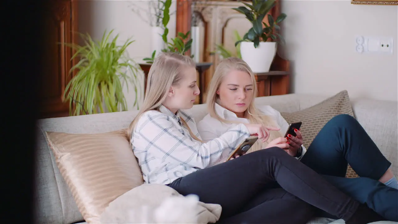 Two Young Womans Doing Online Shopping On Smartphone Browsing Internet Social Media 3