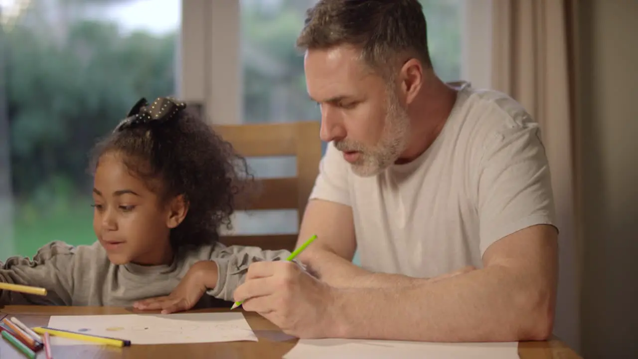 Man and Child Drawing Together