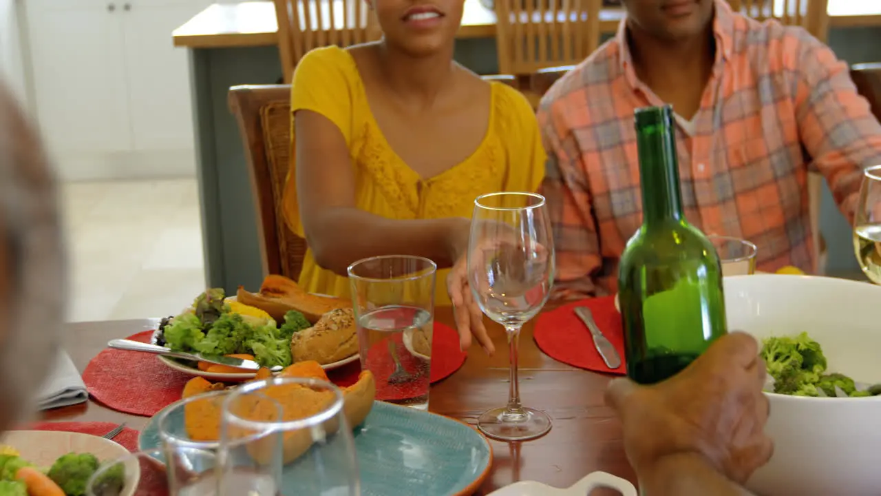 Front view of black family having food at dining table in a comfortable home 4k