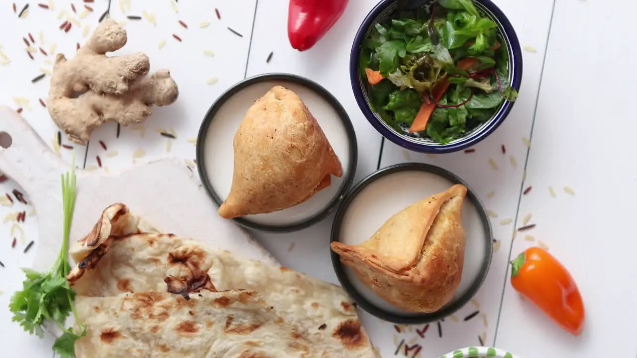 Traditional Indian Food snack Samosa served in a plate on a white wooden table