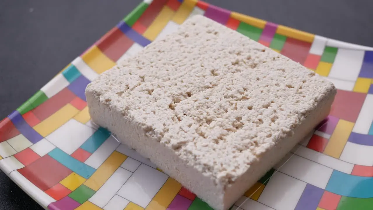 Close up of tofu on a plate on table