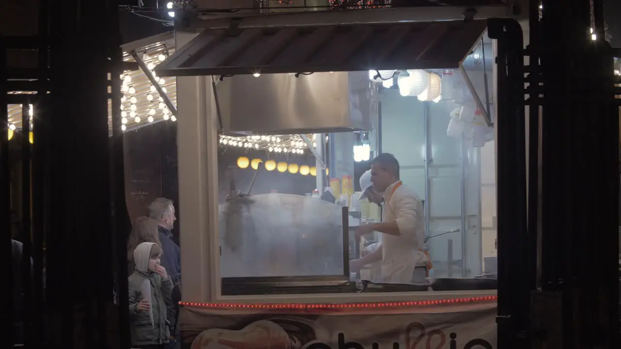 Street food booth with people in queue