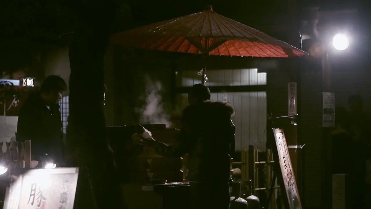 A man buys dinner at the street food cart