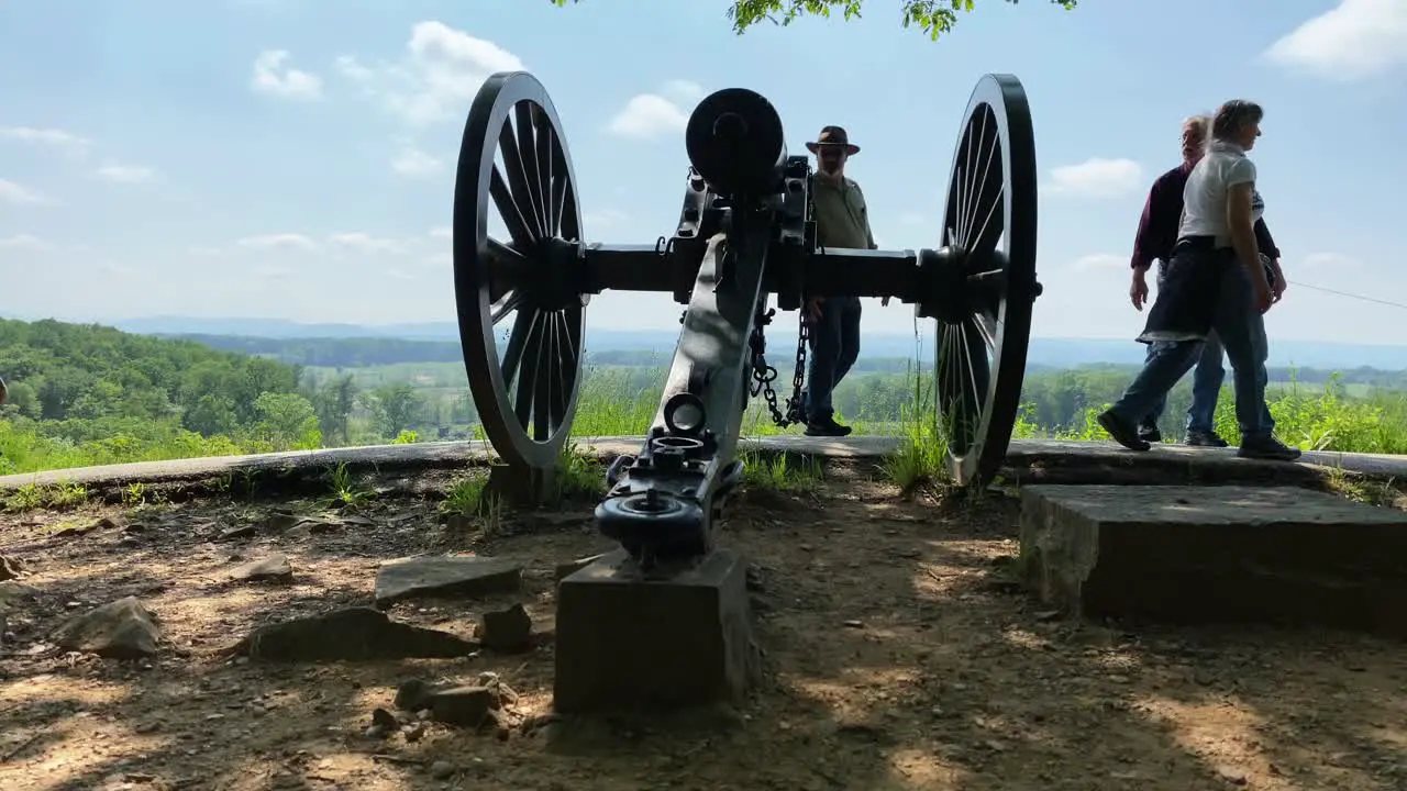 Tourists pass by American Civil War Cannon on battlefield