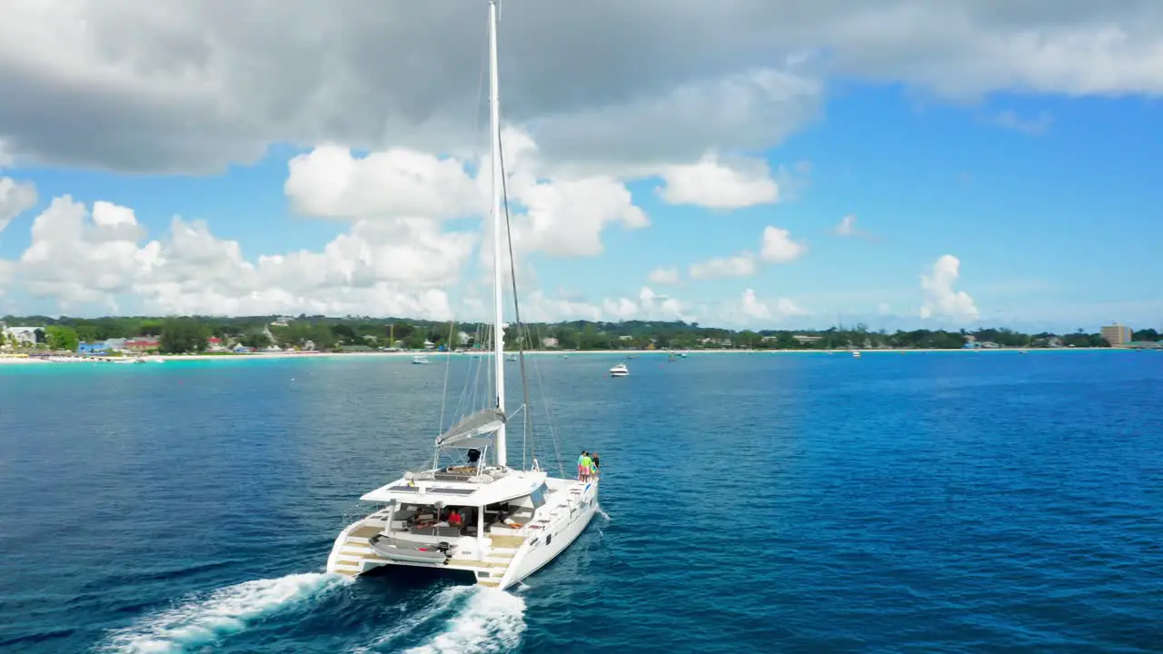 Family on yacht cruising turquoise waters parallax shot