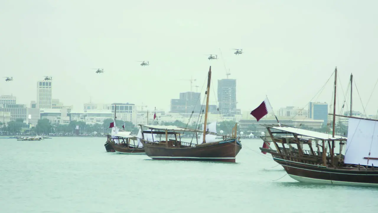 Dhow boats in Qatar with Military Helicopters in the distance