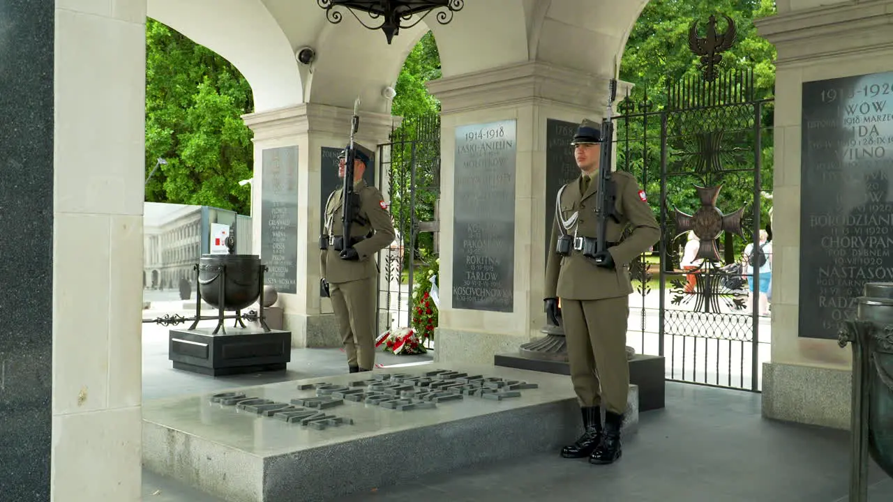 Soldiers guarding a monument with engraved names Tomb of the Unknown Soldier- Warsaw