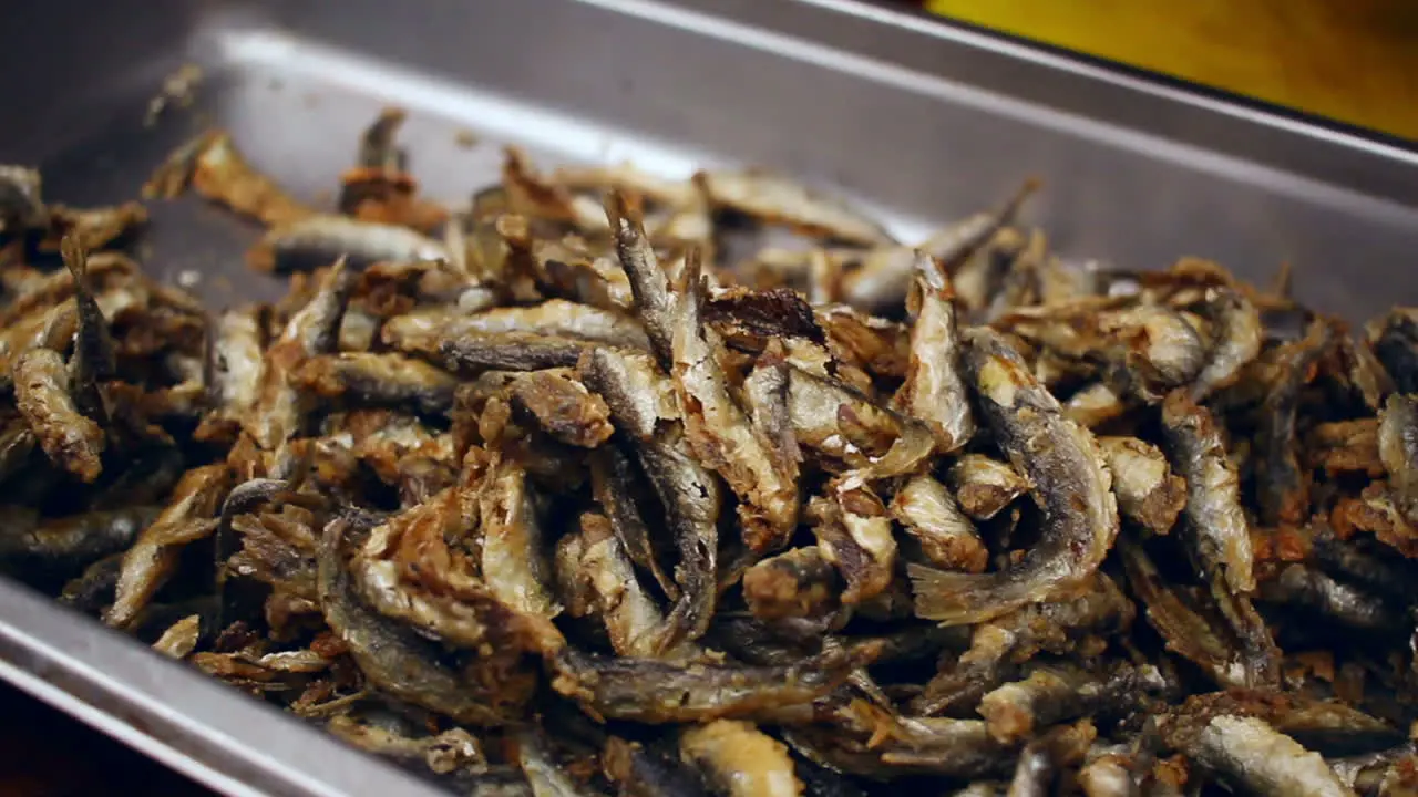 Small fried fish on a big plate Street food Tasty seafood taken by chef