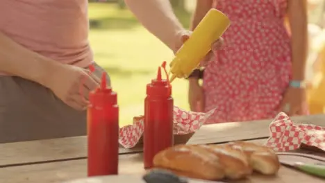 Close Up Shot of Fast Food Stand Worker Passing Hot Dog to a Festival Goer