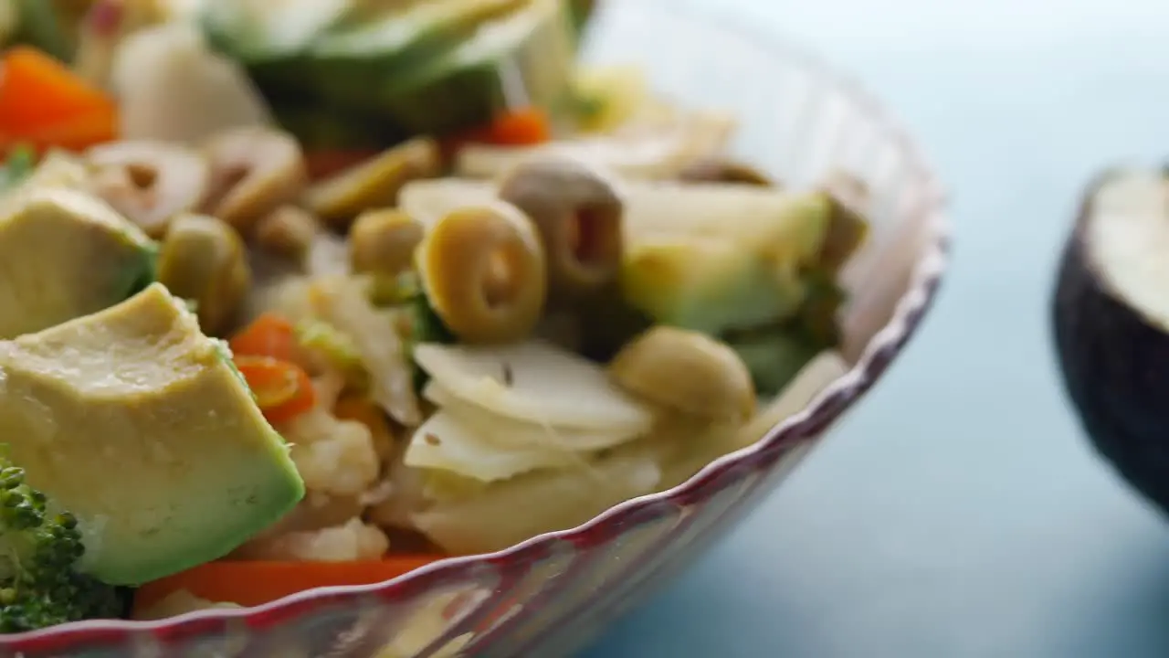 Close up of avocado vegetable salad in a bowl on table 