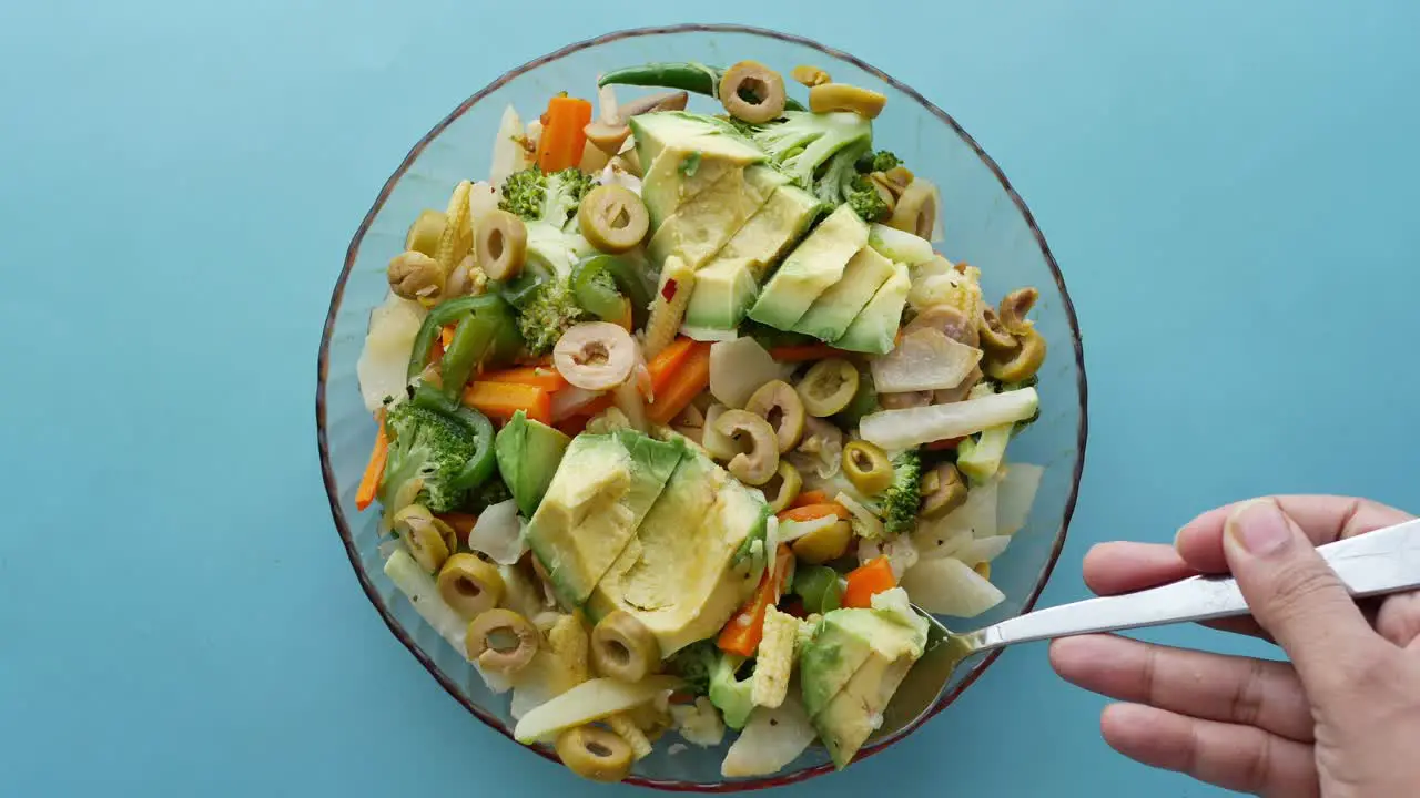 Young women eating avocado salad