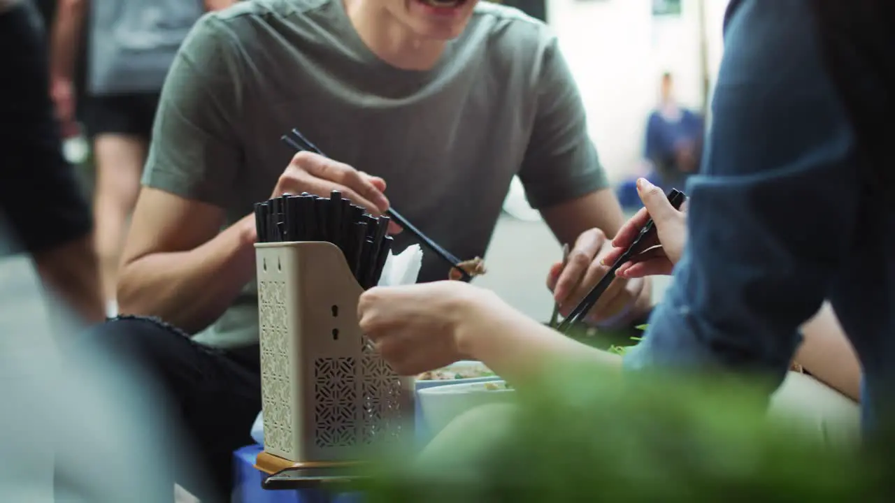 Handheld view of couple enjoying Vietnamese food