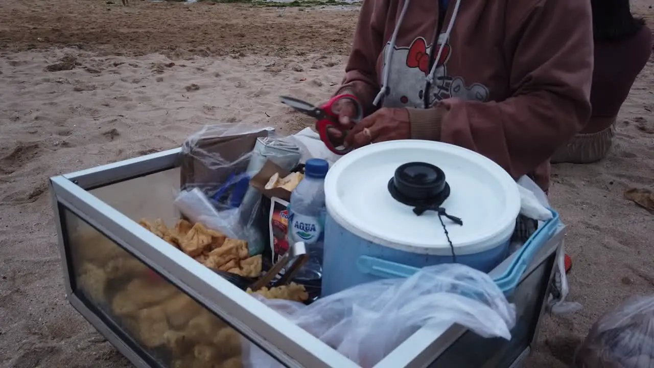 Balinese Old Woman Sells Lumpia Street Fried Food in Bali Indonesia Sanur Beach Tofu and Spring Rolls with Sweet Sauce and Green Chilli