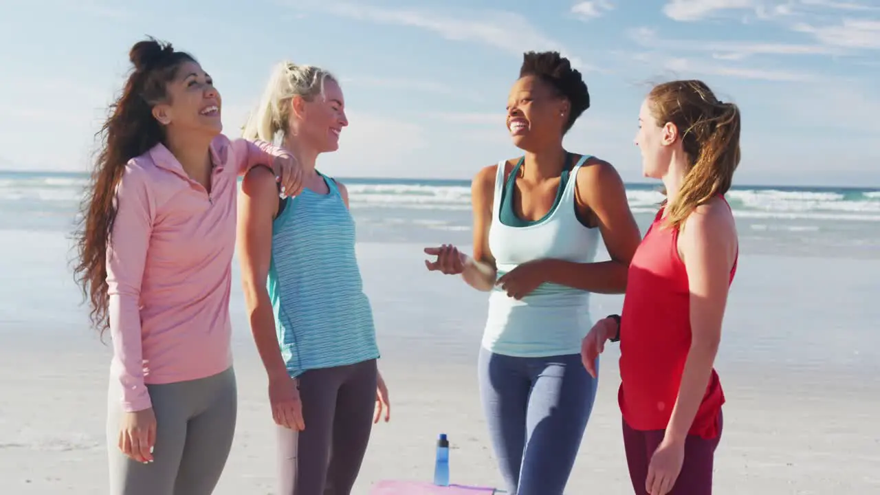 Happy group of diverse female friends having fun at the beach