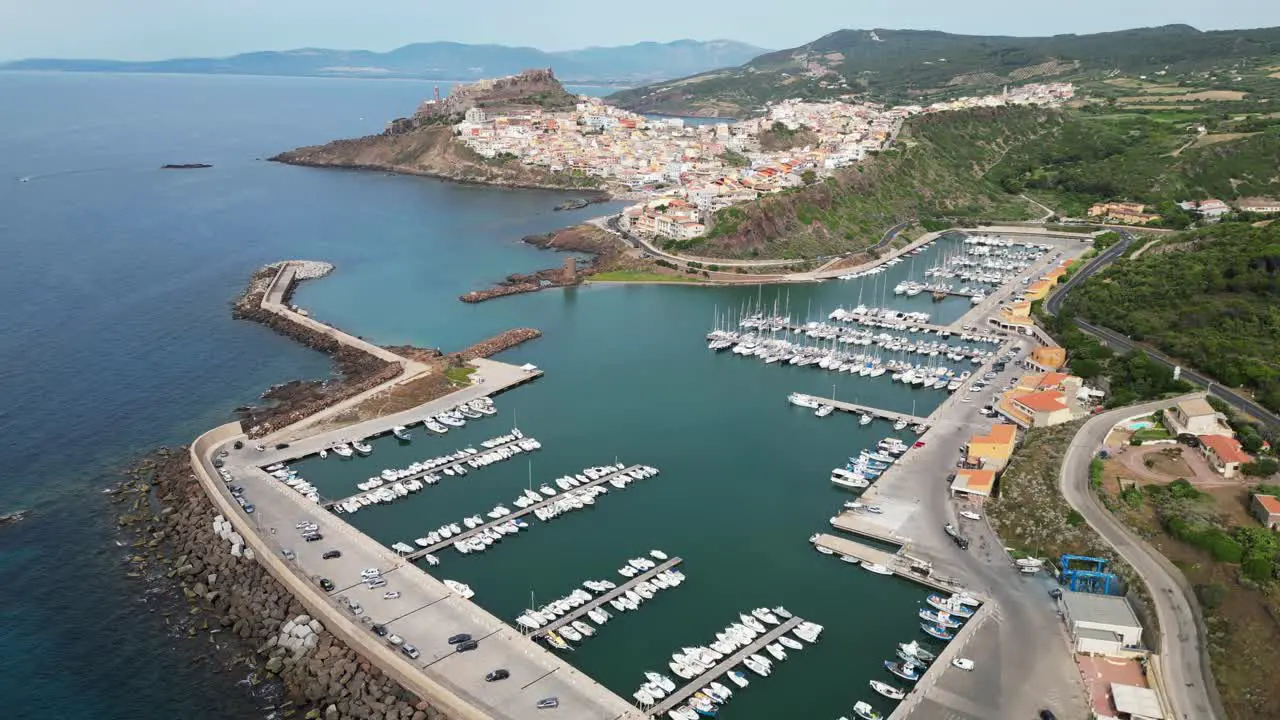 Castelsardo harbor and fortified town in Sardinia Italy 4k Drone Aerial Forward