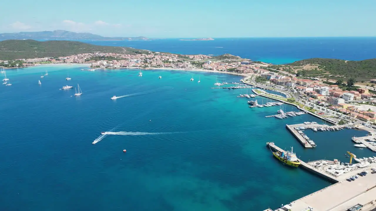 Golfo Aranci Port and coastal town in Sardinia Italy 4k Aerial Backwards