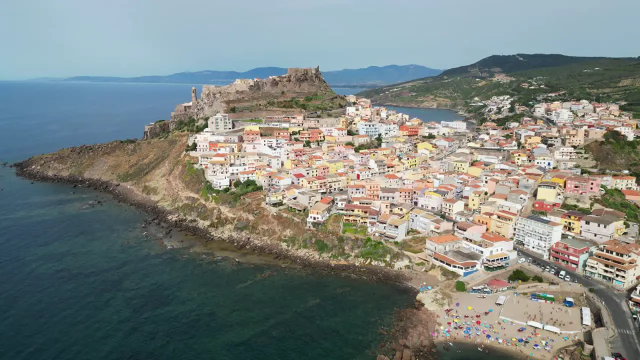 Castelsardo beach and fortified town in Sardinia Italy 4k Drone Aerial Pedestal Up