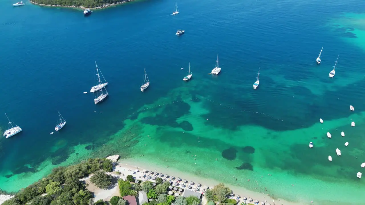 Boats Coastline and Green Island at Syvota Epirus Greece Aerial Reveal