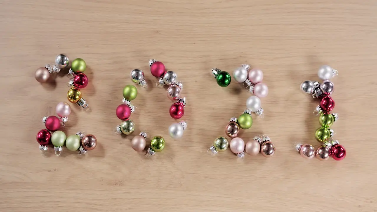 new year twenty twenty one written with Christmas balls sharp to out of focus