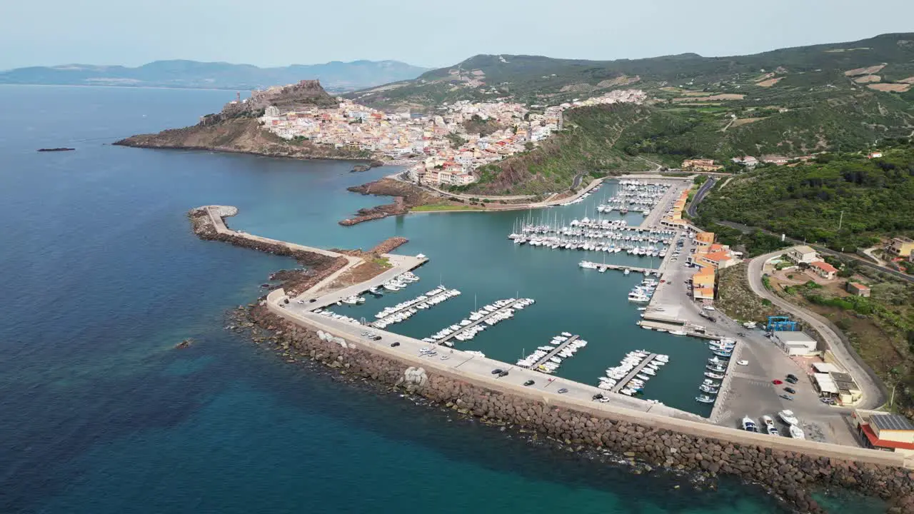 Castelsardo harbor and fortified town in Sardinia Italy 4k Drone Aerial Circling