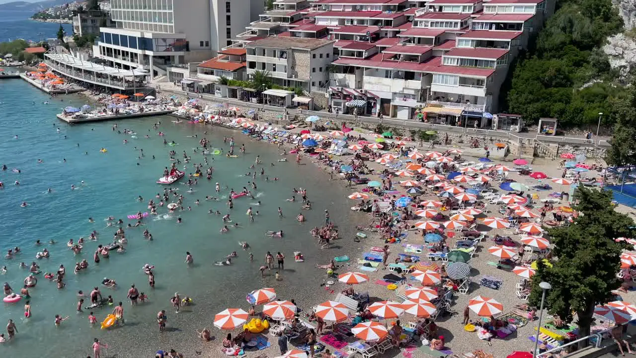 People swimming in shallow sea water during hot summer day