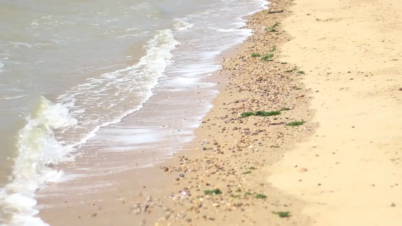 Waves crashing onto a sandy and rocky beach-1