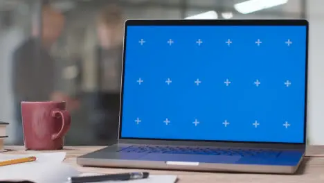 Blue Screen Laptop on Desk In University College Or School