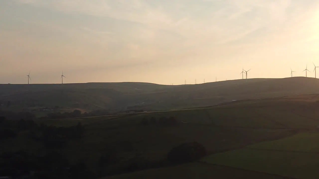 Wind turbine eco farm on beautiful golden hour evening mountain landscape