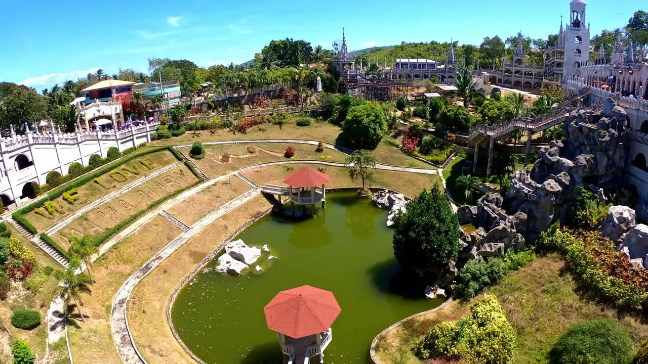 Stable view of the greeny water pond at the center surrounded by the beautiful structure of gothic historic Cathedral Simala Church in Cebu Philippines