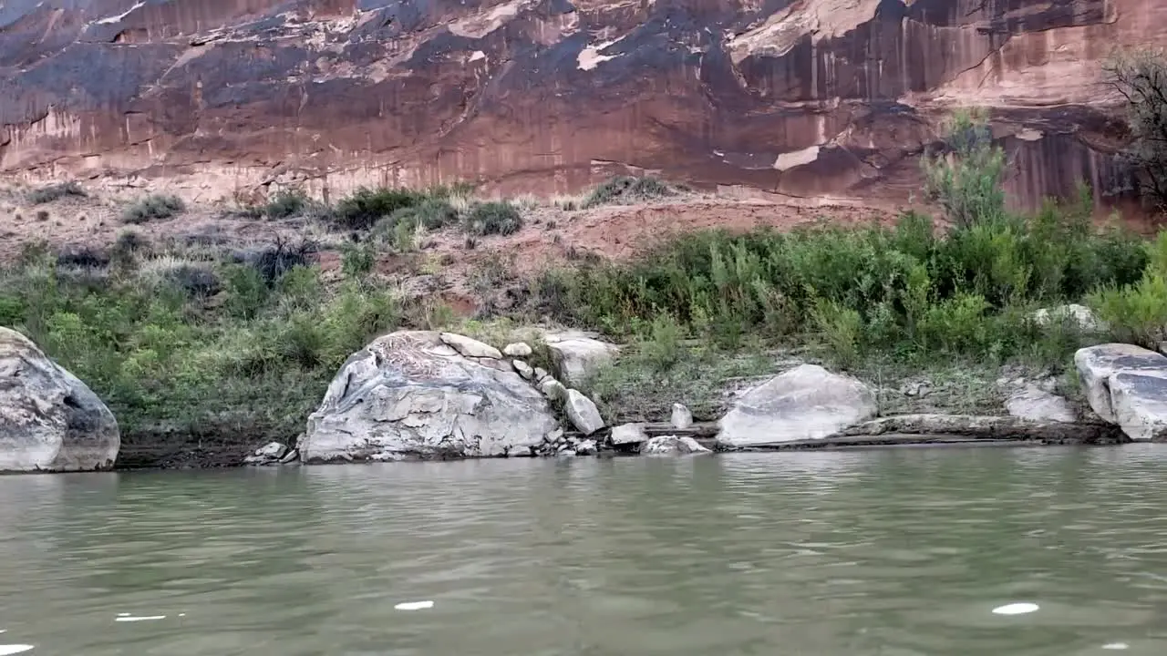 Dolly of canyon wall from river in Utah