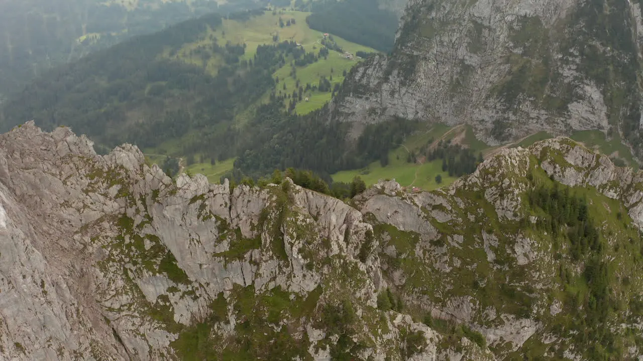 Orbiting drone shot speedramping to reval a summit cross in Switzerland