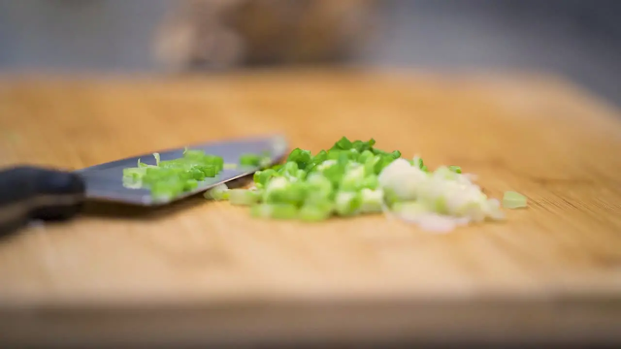 Sliding the cut green onions to the side