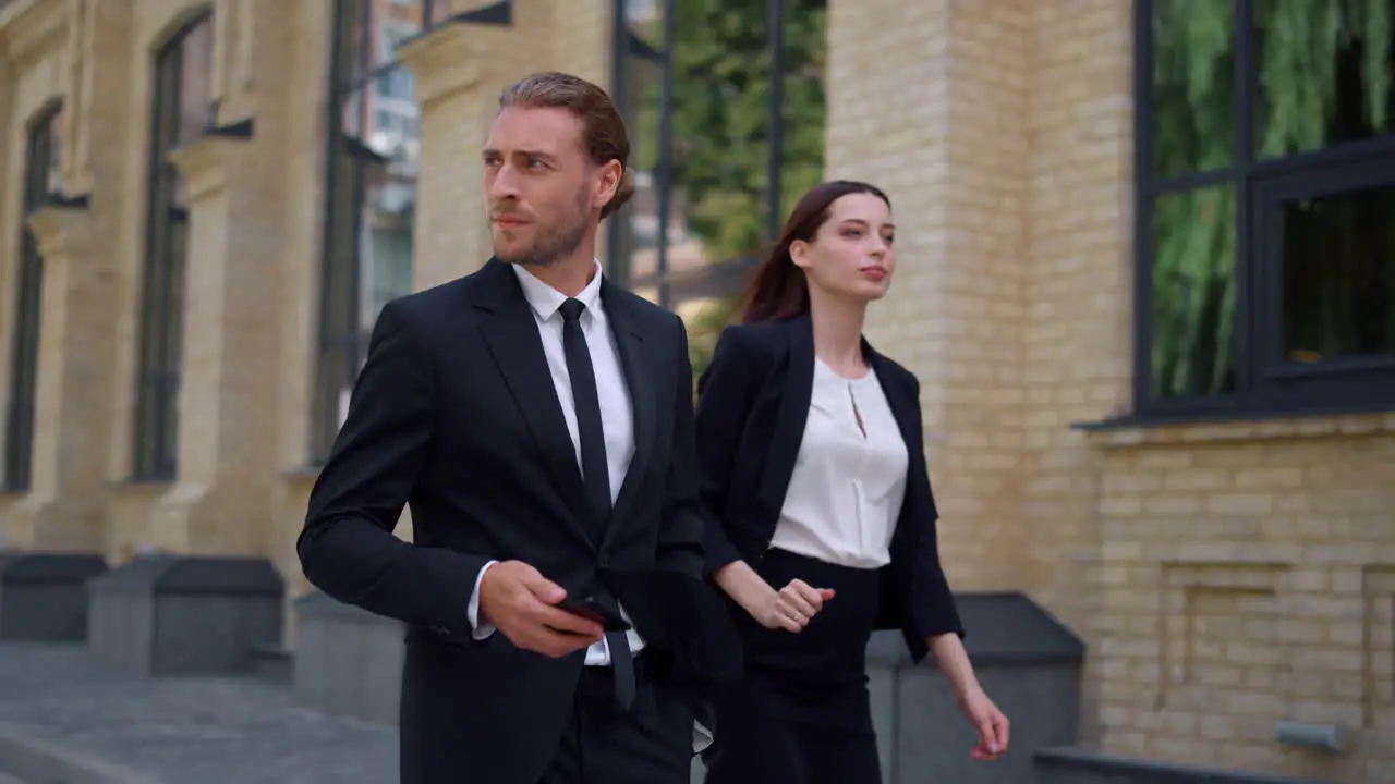 Business man and woman walking to work Colleagues going along city street