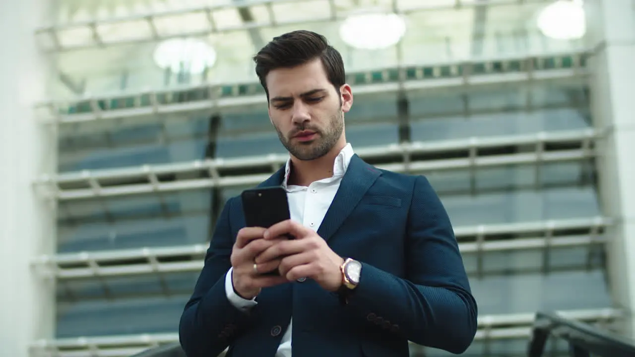 Portrait businessman using phone Man looking away in stylish suit at street