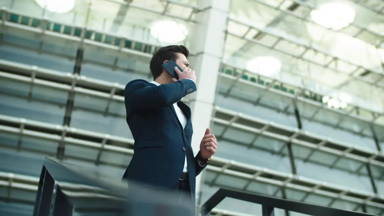 Closeup businessman talking smartphone Businessman smiling with phone outdoors