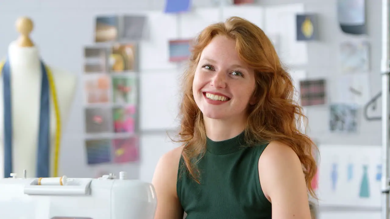 Portrait Of Female Student Or Business Owner Working In Fashion Industry Using Sewing Machine