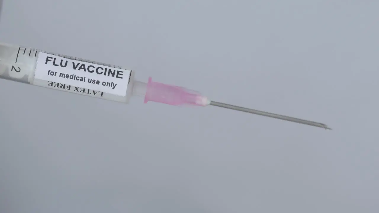 Hand With Syringe To Administer Flu Vaccine close up