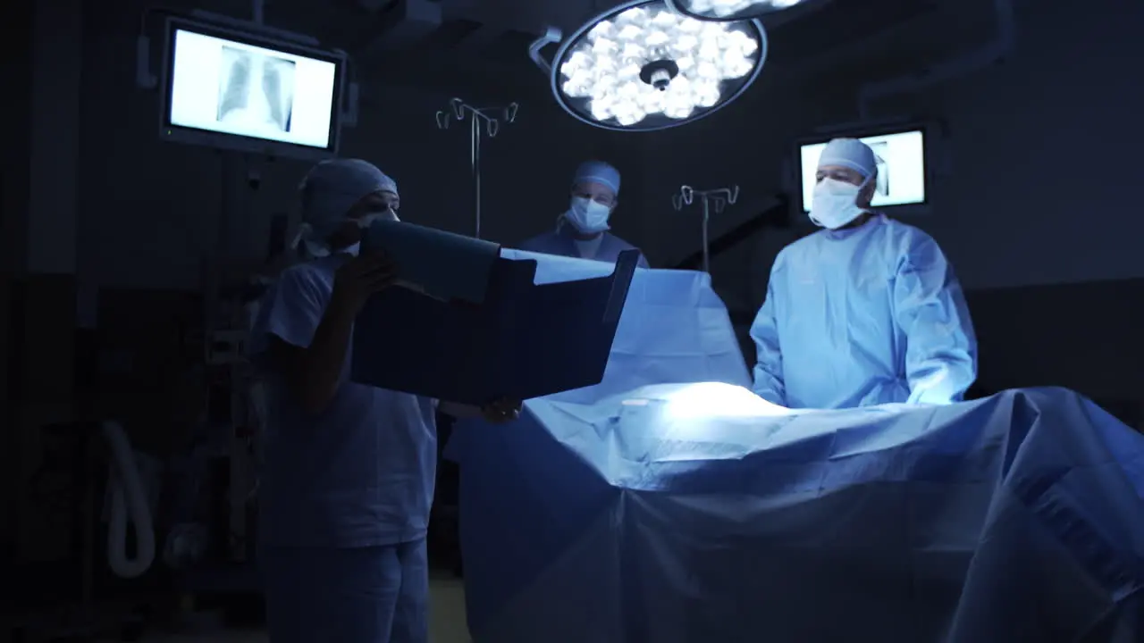 Nurse Reading Patient Chart to Surgeons in Operating Room 4K UHD