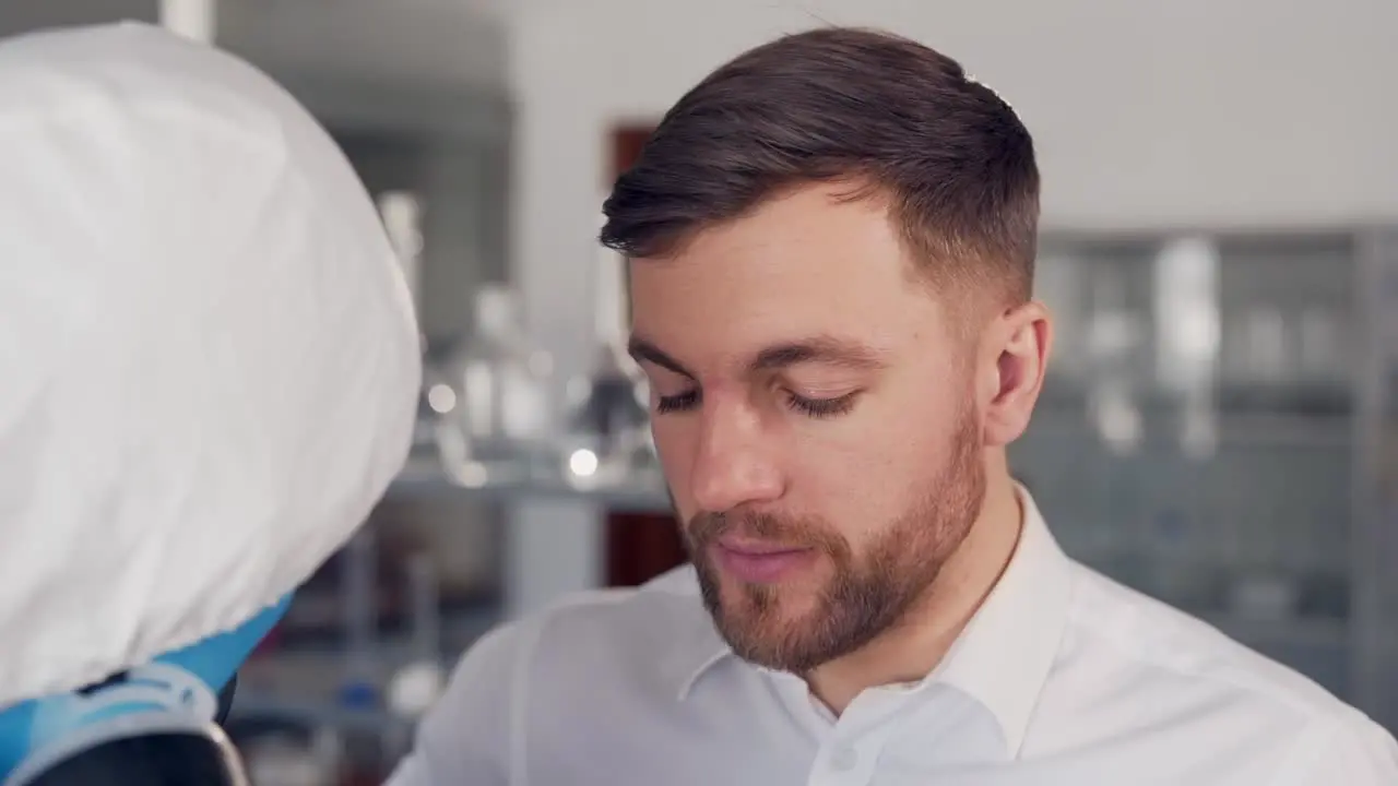 A man in a shirt is being tested for a coronavirus in the lab